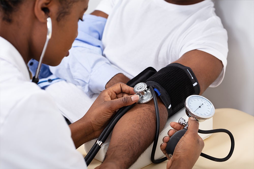 Man taking patients blood pressure